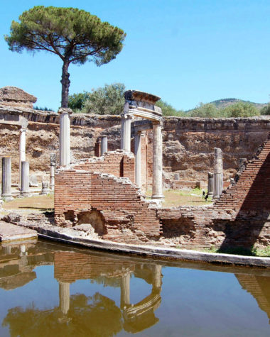 The ruins of Tivoli, with columns surrounding a body of water, and a cypress in the background